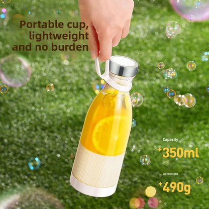 Glass bottle with yellow liquid held by a hand on grass with bubbles
