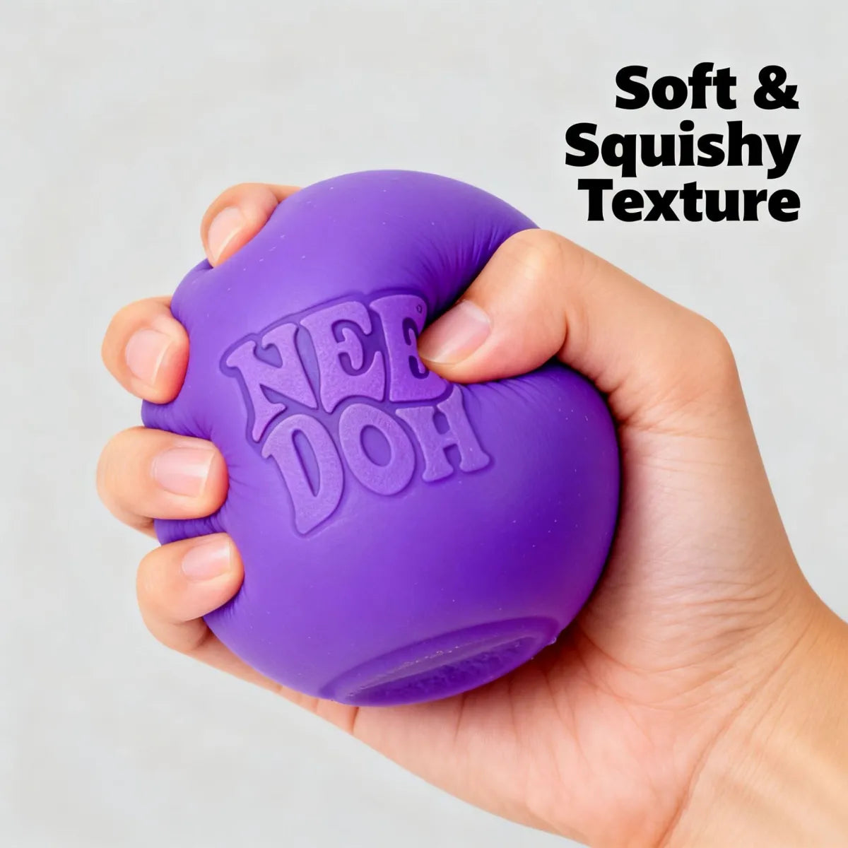 Purple dog toy with 'Air Dog' branding held in a hand against a light gray background.
